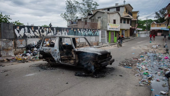 A burned-out car is seen during a protest against insecurity in Port-au-Prince on April 16. Photo / AFP, Clarens Siffroy