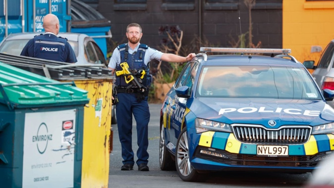 Police, including members of the Armed Offenders Squad, raided the newly minted pad of the North Shore head hunters chapter. Photo / Michael Craig