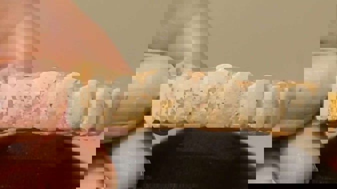 Abuse victim Ellie has made her own "teeth" out of melted beads and fake nails. Photo / Supplied via RNZ