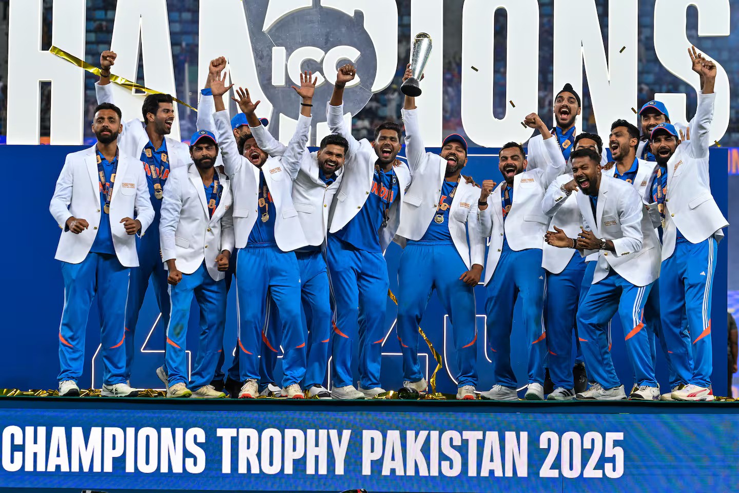 India's players celebrate with the trophy after winning the ICC Champions Trophy final defeating the Black Caps in Dubai. Photo / AFP
