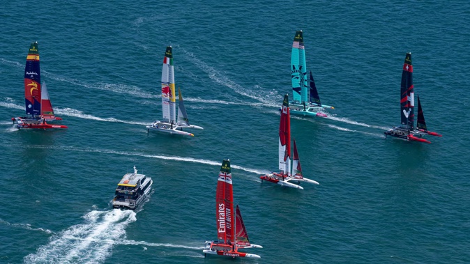 A passenger ferry cuts across the fleet during a practice session ahead of SailGP's debut event in Auckland. Photo / Bob Martin, SailGP.