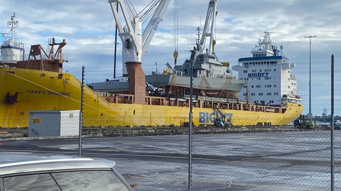 Former Royal New Zealand Navy patrol boats Rotoiti and Pukaki are craned onto a big lift vessel for transfer to Ireland. Photo / George Block