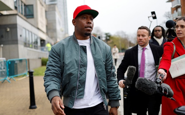 British rapper Dizzee Rascal speaks to the media as he leaves the Croydon Magistrates' Court in London, on 8 April, 2022 following the sentence on his trial for assaulting his ex-fiancee. Photo / RNZ