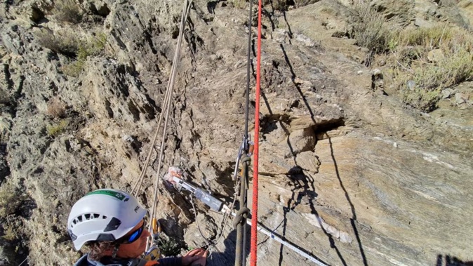 Wayo Carson at work keeping our roads safe, at Nevis Bluff, near Arrowtown. Photo / Elizabeth Hannon WSP/ Aspiring Highways