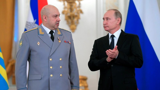 Russian President Vladimir Putin applauds Colonel General Sergei Surovikin during an awards ceremony for troops who fought in Syria. Photo / AP