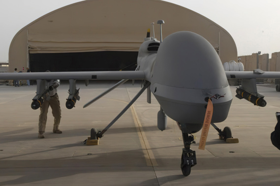 Contactors from General Atomics load Hellfire missiles onto an MQ-1C Gray Eagle at Camp Taji, Iraq. Photo / AP