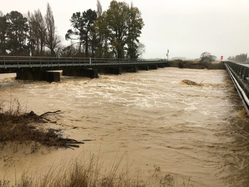 Heavy flooding by Hinds River bridge SH1 between Ashburton and Hinds. Photo / Hamish Clark