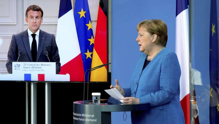 French President Emmanuel Macron is seen on a video screen during a joint press conference with German Chancellor Angela Merkel, right, as part of a virtual Plenary Session of the Franco-German Council of Ministers in Berlin, Germany. (Photo / AP) 