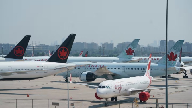 Air Canada airplanes stand on the tarmac at Pearson International Airport in Toronto on August 16, 2025. Photo / Peter Power, AFP)