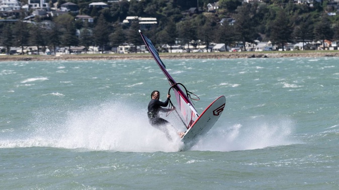 Wind surfer Lyall McLennan, from Napier, making the most of the weather on Sunday. Photo / Connull Lang