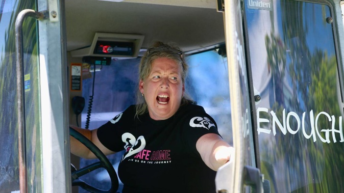 A woman driving one of the many tractors that have converged in Auckland's CBD. (Photo / Alex Burton)
