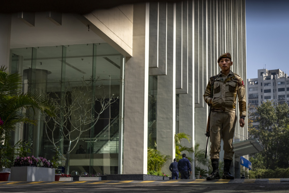 An armed security person stands stand guard at the gate of a building housing BBC office in New Delhi, India. Photo / AP