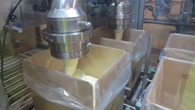 Hot cream cheese being packed at Fonterra's Darfield plant for Asian markets. Photo / RNZ, Cosmo Kentish-Barnes