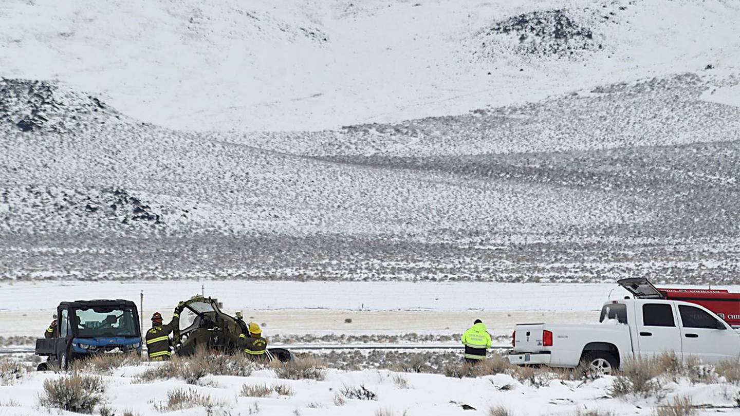 Rescue staff at the Care Flight medical transport plane crash site. Photo / AP