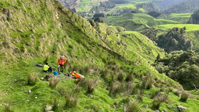 The hunter was found face down and motionless halfway down a steep hill. (Photo / Colin Wright)