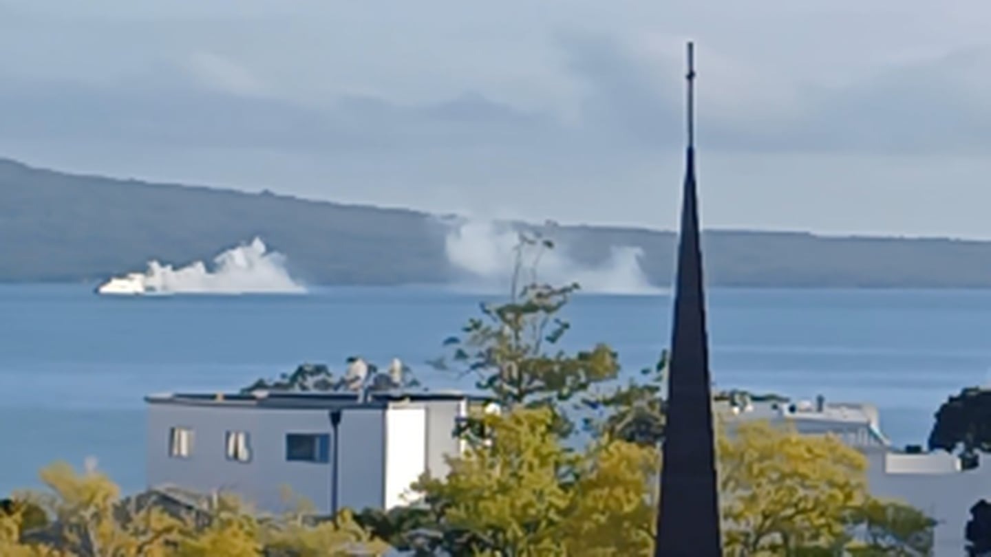 A vessel on the Waitematā Harbour appears to be on fire with smoke streaming out the back of it. Photo / Mel Abbott