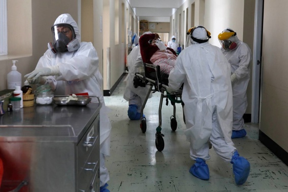 Medical staff transport a Covid-19 patient at the Honorio Delgado Hospital in Arequipa, Peru. The nation currently has the highest mortality rate of anywhere in the world. (Photo / AP)
