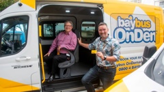 Bay of Plenty Regional Council public transport committee chairman, Andrew von Dadelszen, left, and the council's director public transport, Mike Seabourne with the Baybus OnDemand vehicles. Photo / BOPRC