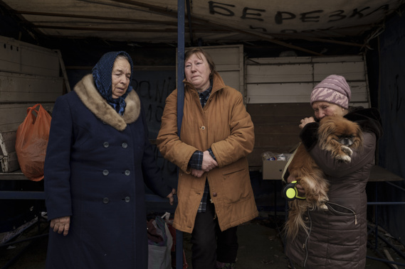 People fleeing the village of Ruska Lozova wait at a screening point in Kharkiv, Ukraine. (Photo / AP)