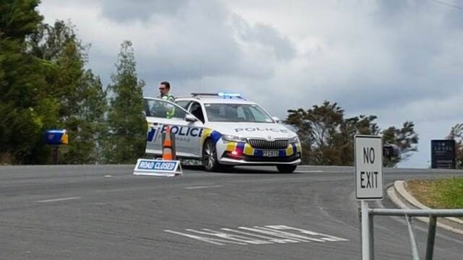 Police at the scene of Monday's incident in which a roadworker died on Abbey Caves Rd. Photo / Mike Dinsdale