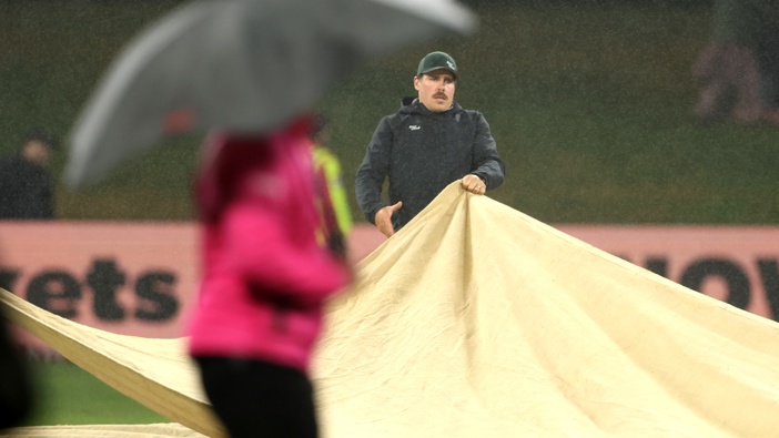 The covers are pulled back on as the rain arrives during the second match in the T20 International series between New Zealand and Australia at Bay Oval on October 03, 2025 in Mount Maunganui, New Zealand. (Photo by Phil Walter/Getty Images)
