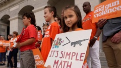 Elise Schering, 7, displays a simple message during a National Gun Violence Awareness rally at the Capitol in Sacramento. Photo / AP