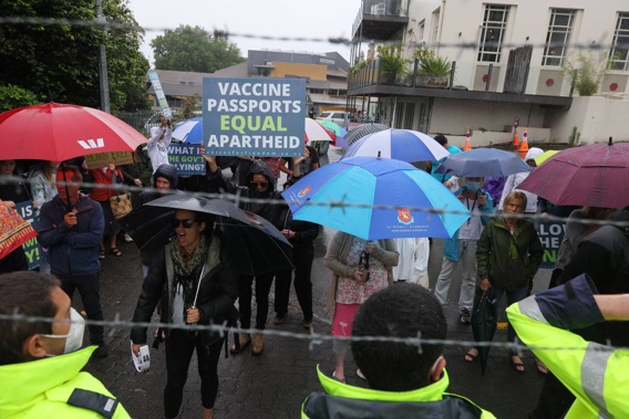Protesters start chanting outside a sod turning event for the Waikato Regional Theatre in Hamilton CBD today that Prime Minister Jacinda Ardern is attending. (Photo / Mike Scott)