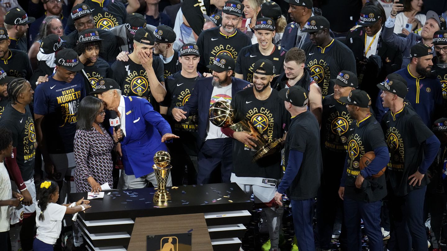 Denver Nuggets players, coaches and owners hold up the Larry O'Brien trophy after the team's victory over the Miami Heat. Photo / AP