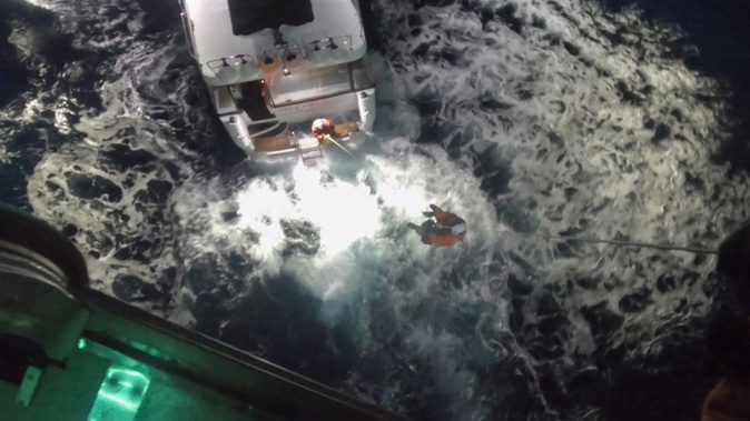 A paramedic is winched down to the vessel to rescue a patient who had suffered a “serious medical event”. Photo / NEST
