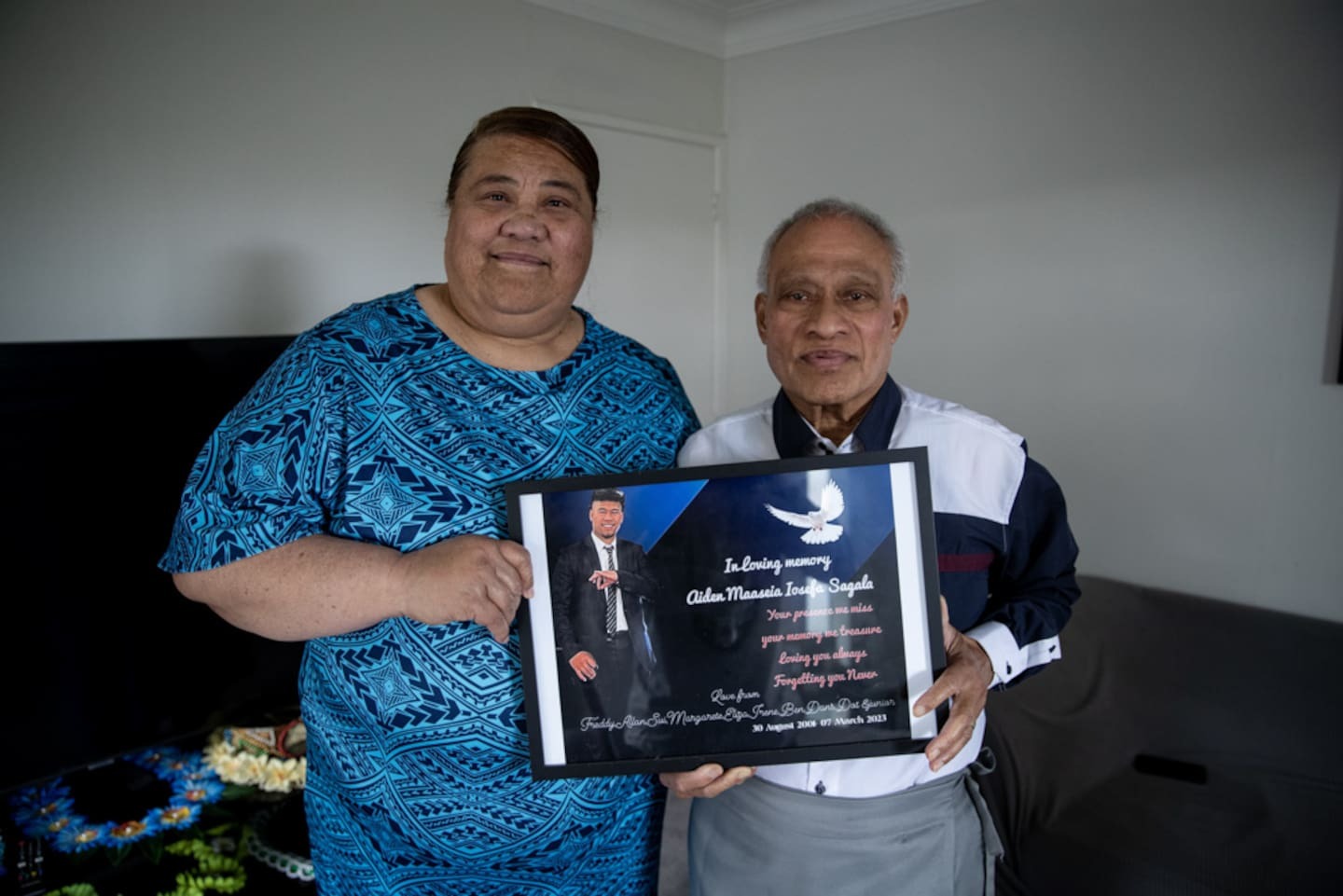 Parents Lila Sagala and Ma'a Sagala hold a photograph of their son Aiden Sagala who died after unknowingly consuming liquid meth from a beer can. Photo / Dean Purcell