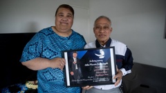 Parents Lila Sagala and Ma'a Sagala hold a photograph of their son Aiden Sagala who died after unknowingly consuming liquid meth from a beer can. Photo / Dean Purcell