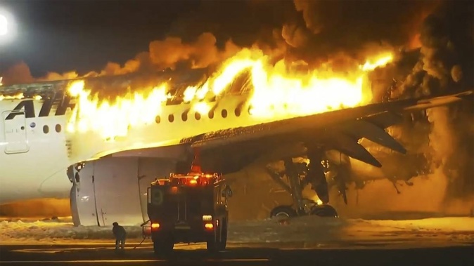 Japan Airlines plane is on fire on the runway of Haneda airport. Photo / AP