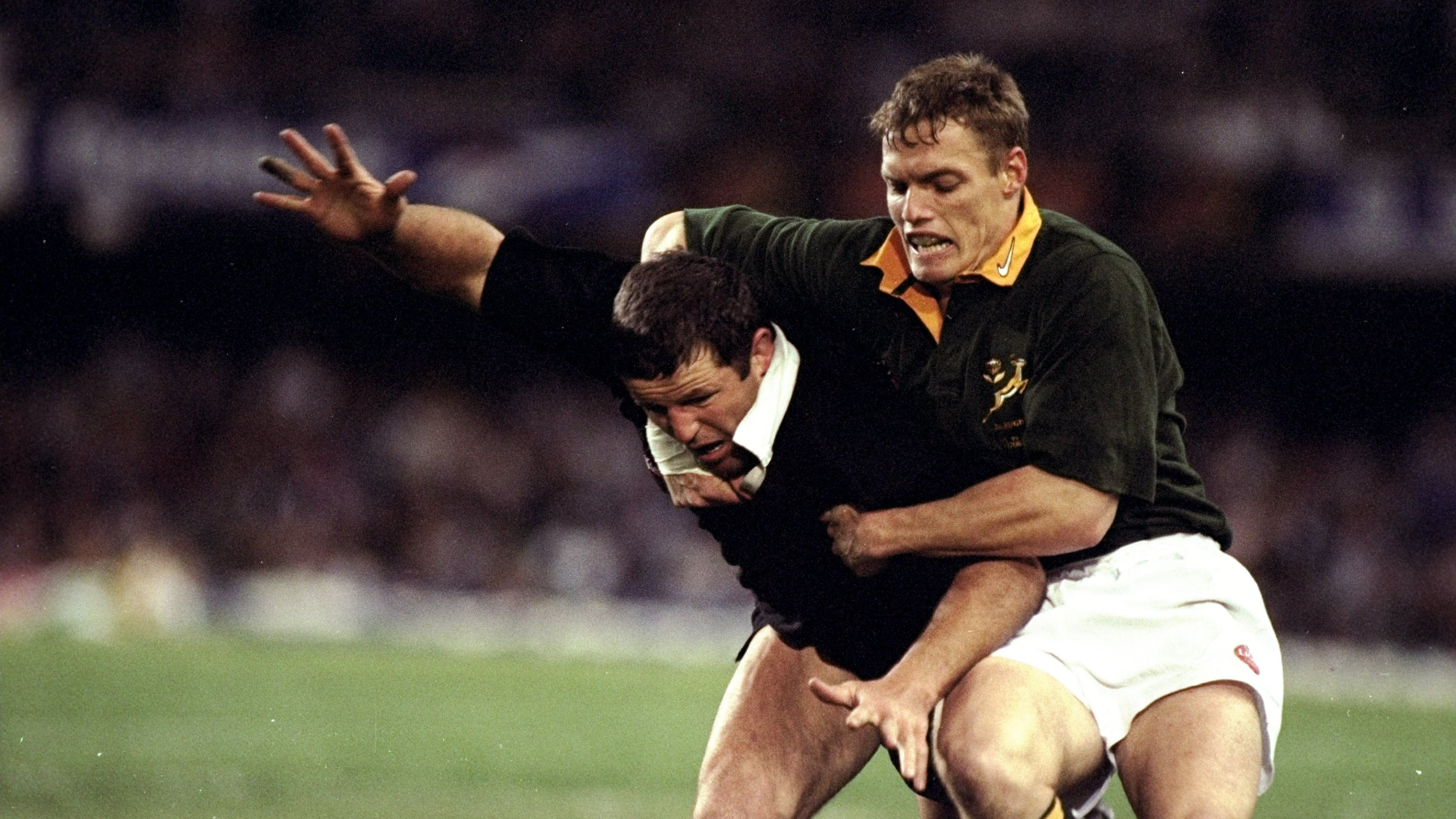 17 Aug 1996: Sean Fitzpatrick of New Zealand is held by Justin Smart of South Africa during the First Test match in South Africa. Credit: David Rogers/Allsport