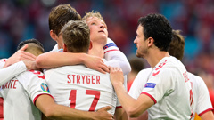 Denmark's Dolberg celebrates with teammates after scoring his side's second goal against Wales. (Photo / AP)