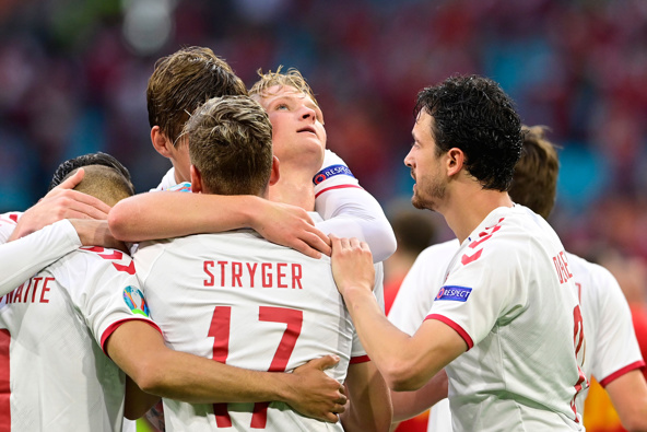 Denmark's Dolberg celebrates with teammates after scoring his side's second goal against Wales. (Photo / AP)