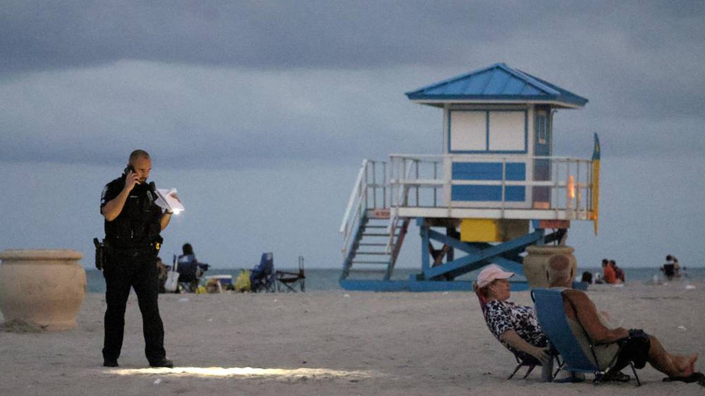 A police officer investigates the shooting on Florida's Hollywood Beach. Photo / AP