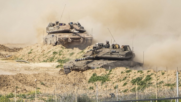Israeli soldiers drive tanks inside Gaza Strip, as seen from southern Israel, Tuesday, Feb. 13, 2024. Photo / AP