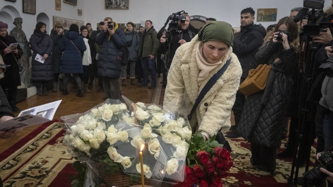 People lay flowers to commemorate Chris Parry and Andrew Bagshaw, two British volunteers killed in eastern Ukraine, during a commemorating service in a refectory near St. Sophia Cathedral in Kyiv, Ukraine. Photo / AP
