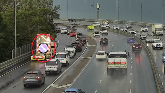Surface flooding shut down a lane on SH1 north of the Harbour Bridge this afternoon. Photo / Supplied