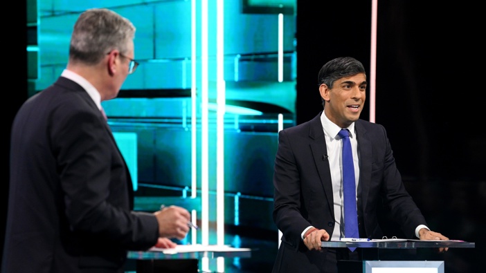 In this handout provided by ITV, Labour Party leader Keir Starmer (L) and Prime Minister Rishi Sunak speak on stage during the first head-to-head debate of the General Election on June 4, 2024 in Salford, England. Photo / Jonathan Hordle - ITV via Getty Images