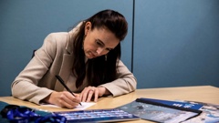 Prime Minister Jacinda Ardern writes a note the future prime minister who will host Apec at a future date - maybe 20 years away. (Photo / Supplied)
