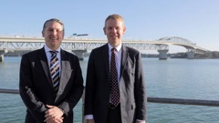 Former Transport Minister Michael Woods and former Prime Minister Chris Hipkins in front of the Auckland Harbour Bridge ahead of an announcement about new Waitematā Harbour crossing options in March. Photo / Michael Craig