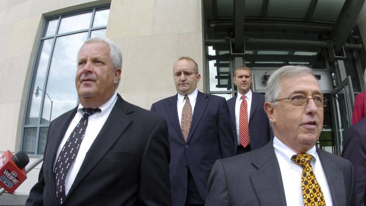 Former Luzerne County Court Judges Michael Conahan, front left, and Mark Ciavarella, front right, leave the United States District Courthouse. Photo / AP