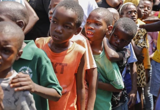 Children line up to receive a plate of food at a shelter for families displaced by gang violence, in Port-au-Prince, Haiti. Photo / AP