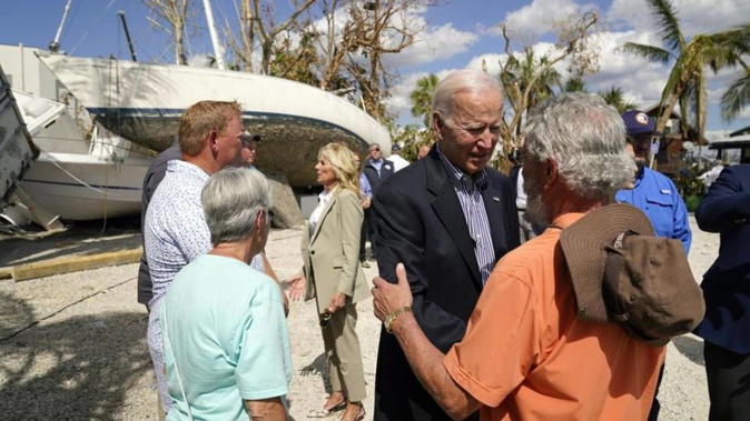 President Joe Biden and first lady Jill Biden talk to people impacted by Hurricane Ian during a tour of the area. Photo / AP