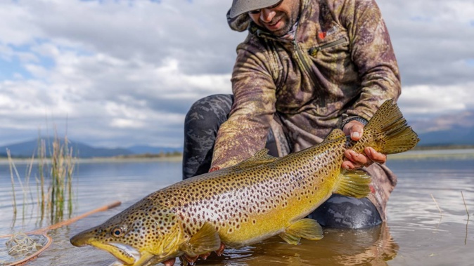 Dion James' winning fishing photo which appeared on DOC fisheries Licences for 2023. Photo / Supplied