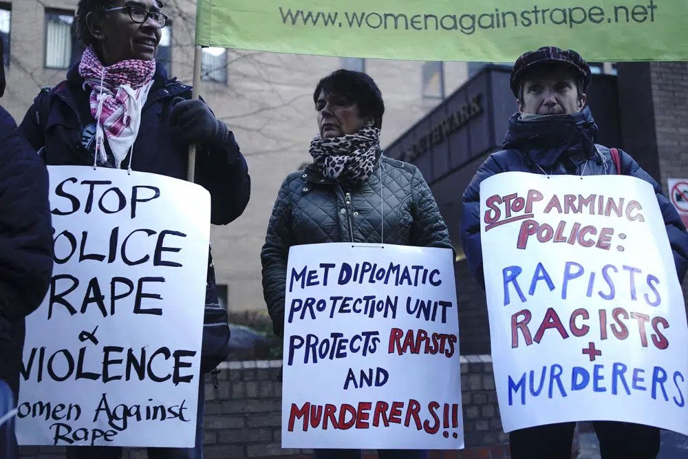 Protesters from Women Against Rape & Women of Colour in the Global Women's Strike, protest outside Southwark Crown Court in London ahead of the sentencing of former police officer David Carrick, Tuesday Feb. 7, 2023. Former London police officer, Carrick, was sentenced Tuesday to life in prison with a minimum term of 30 years for raping and sexually assaulting a dozen women over a 17-year period. (Victoria Jones/PA via AP)