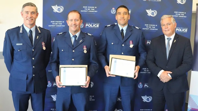 Police Commissioner Andrew Coster with Central Hawke’s Bay officers Sergeant Neil Baker and Sergeant Damion Davies with their commendations, and Police Minister Mark Mitchell.