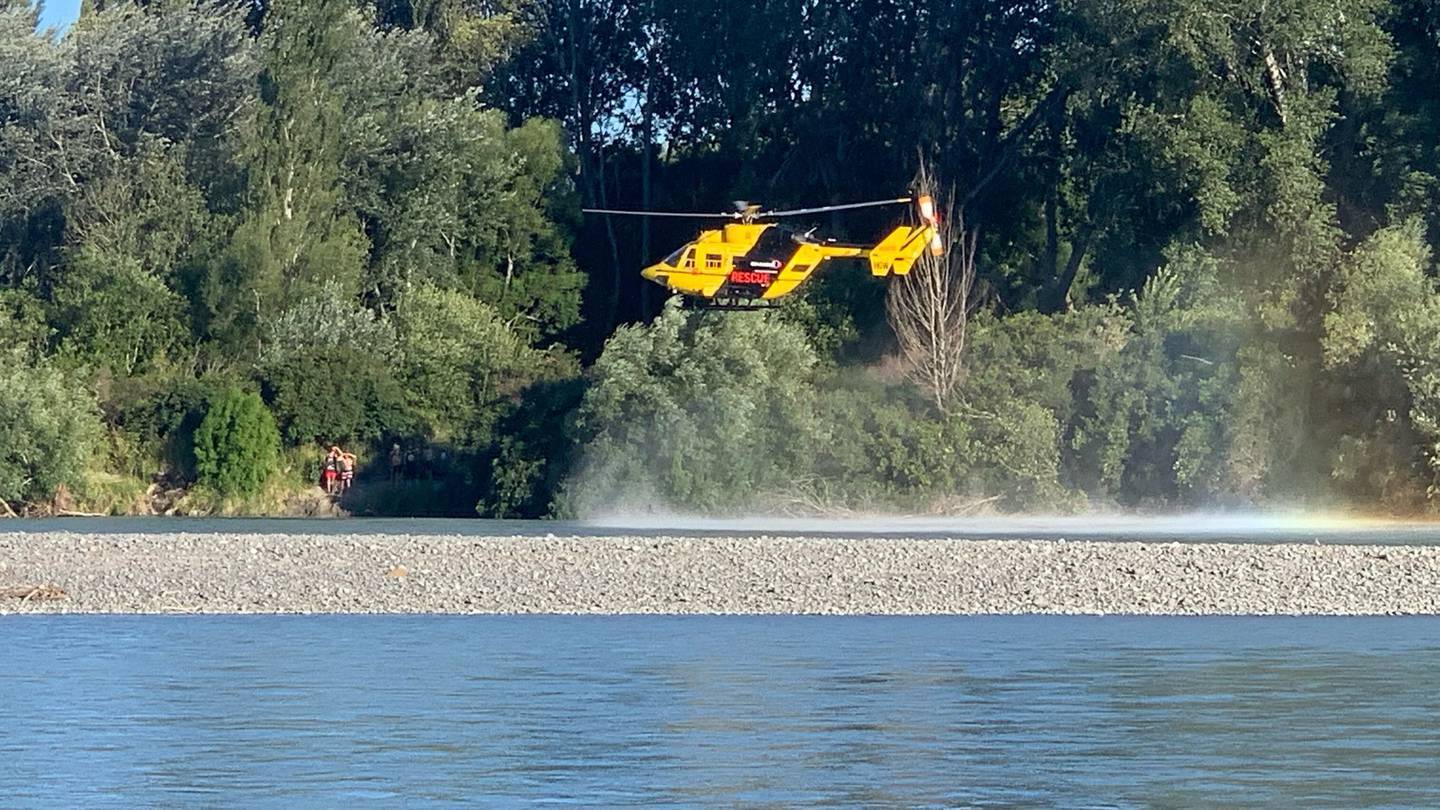 A helicopter hovers over the Waimakariri River in Canterbury after a swimmer disappeared after failing to surface following jumping in the river. (Photo / Flynn Parker)