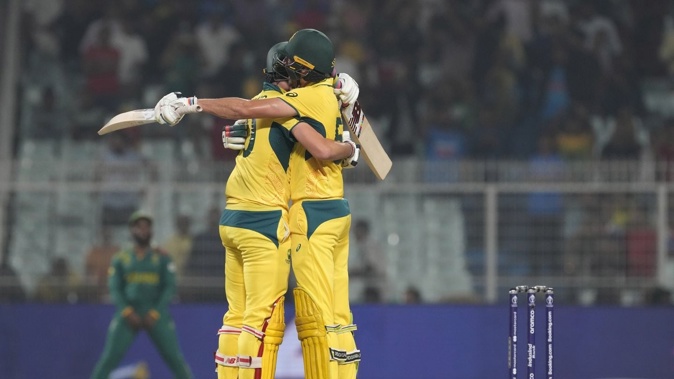 Australia's captain Pat Cummins and Mitchell Starc celebrate their win over South Africa in Kolkata. Photo / AP